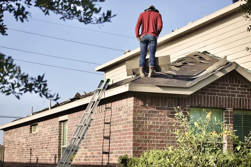 Professional roofer working on a residential roof in Bryan Hill Manor